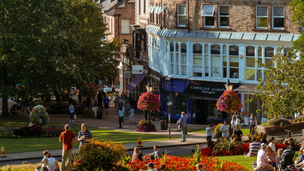 People walking through Harrogate town centre on a sunny day.