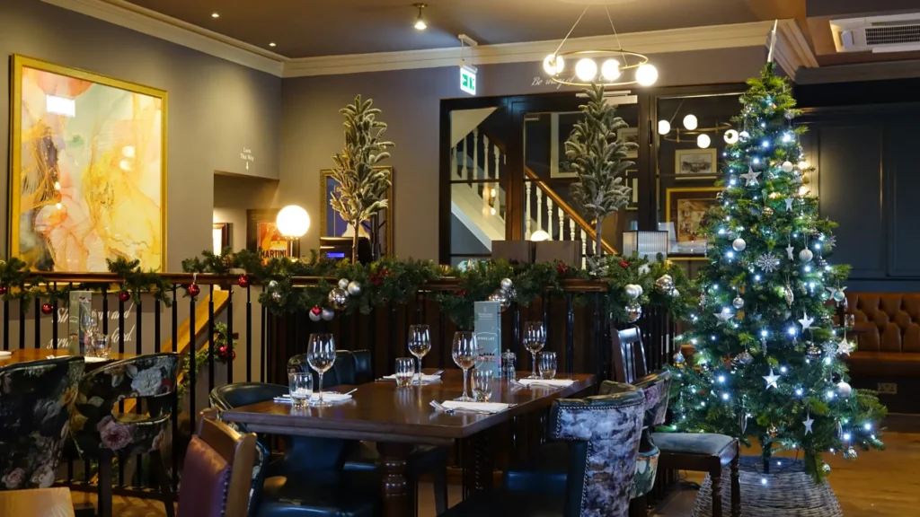 The Coach and Horses set for a festive meal decorated with a Christmas tree and garlands.