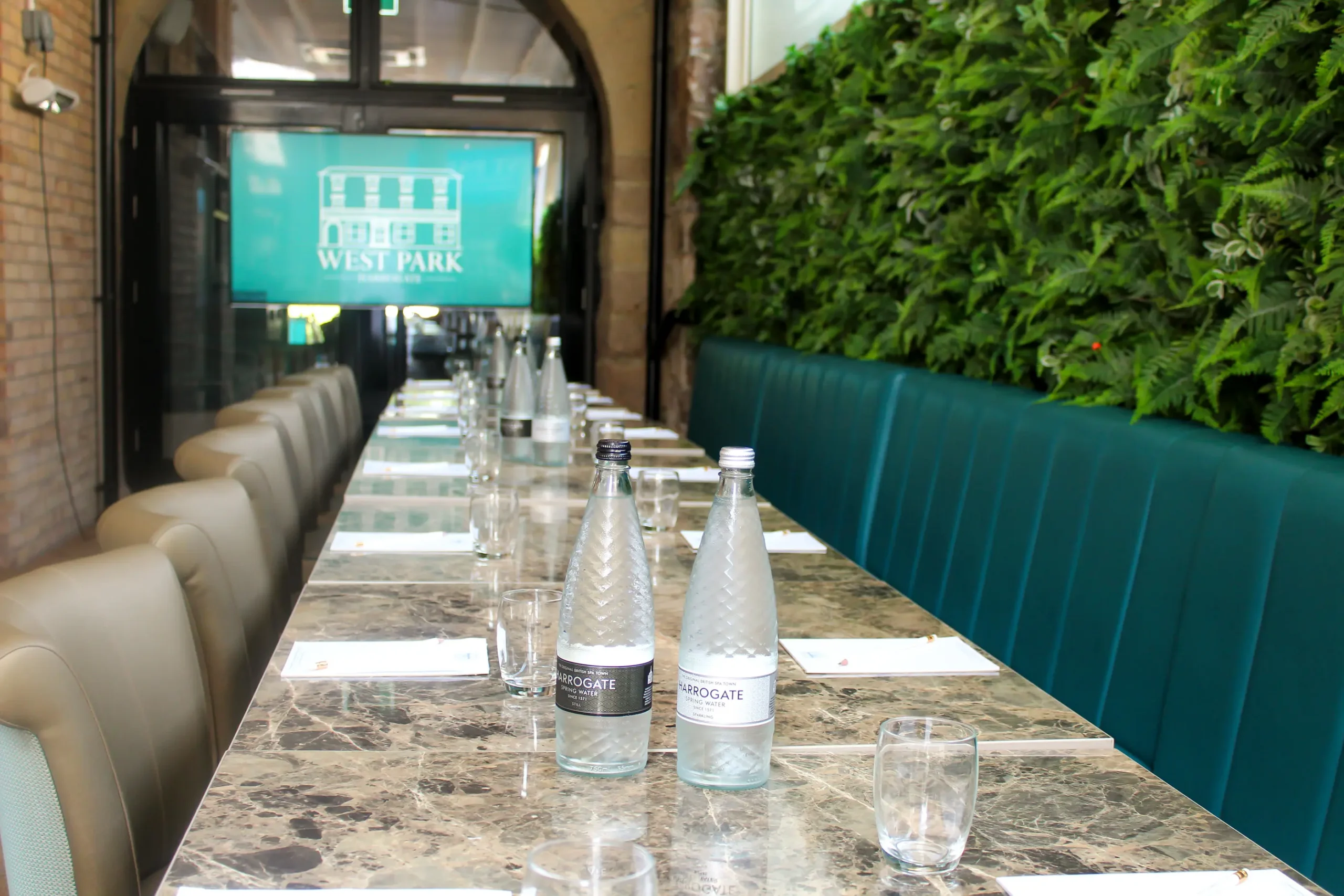 set up of a corporate event space at west park hotel with tables and chairs