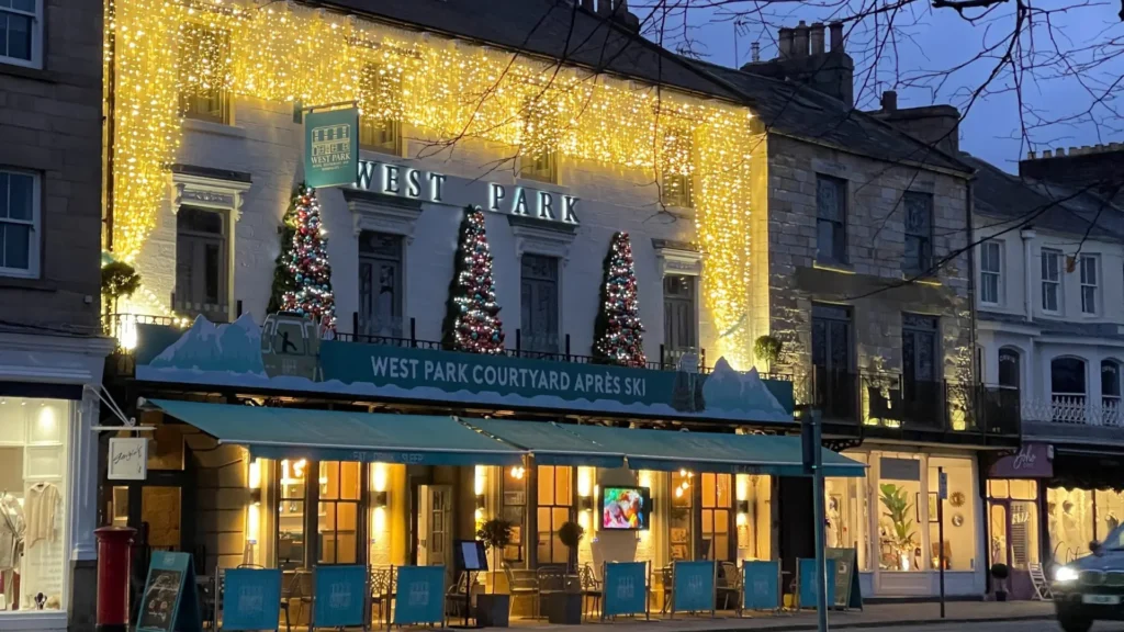 Exterior shot of The West Park Hotel in Harrogate featuring Christmas trees and gold fairy lights.